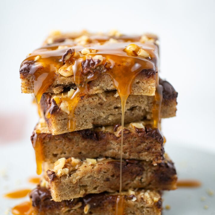 Banana Chocolate Chip Bars stacked with caramel drizzling off the edges