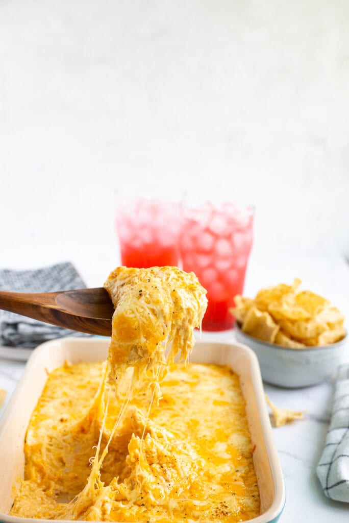 Scoop of Buffalo Chicken Dip being pulled from casserole dish