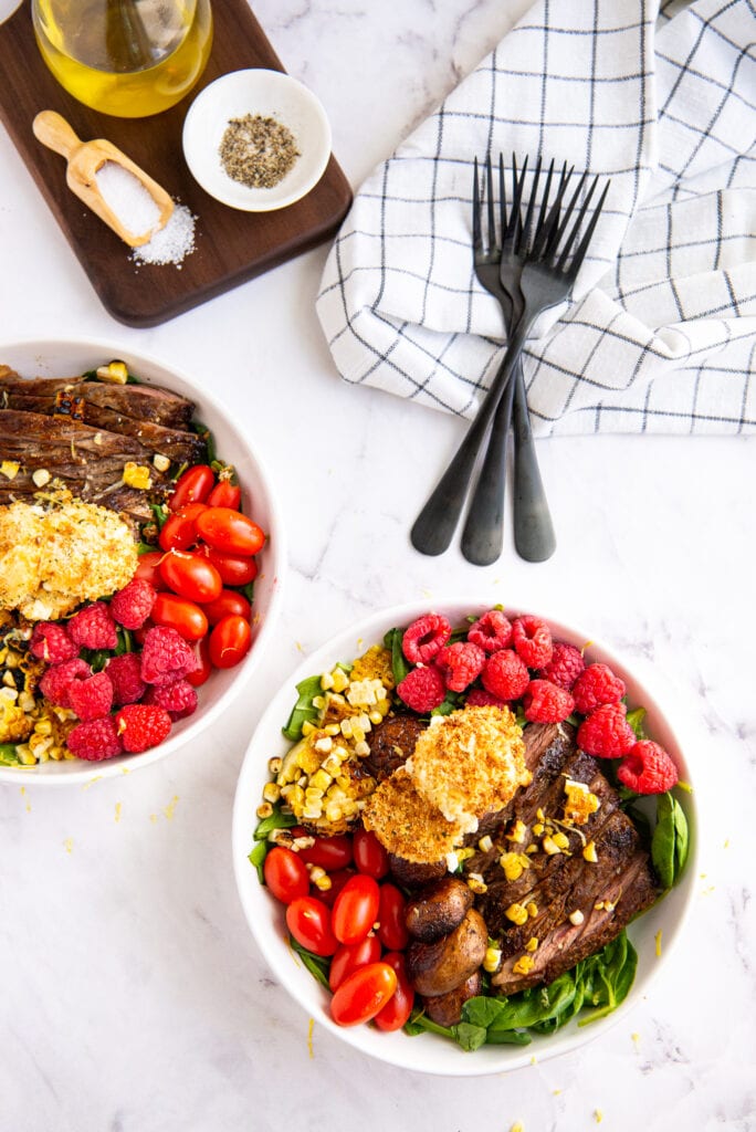 Two bowls of Balsamic Steak Salad with black forks